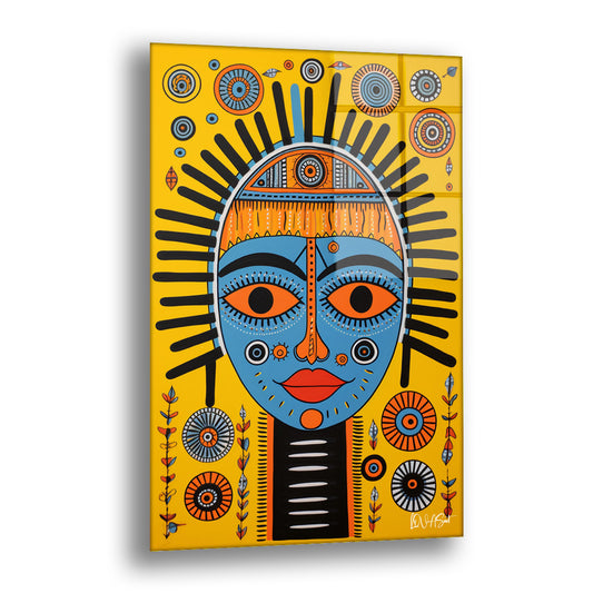 Sarı Afrika Maskesi cam tablo — sarı zeminde çok renkli desenlerle çevrili mavi bir maske yüzünün grafik gücünü taşır.